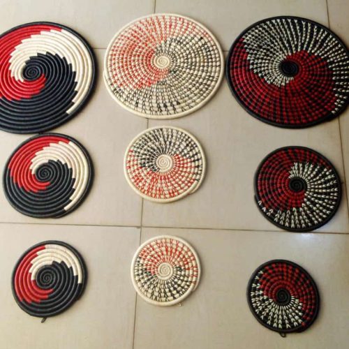 A SET OF THREE WALL HANGING HAND WOVEEN BASKETS