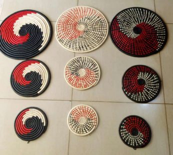 A SET OF THREE WALL HANGING HAND WOVEEN BASKETS